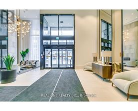 A reception area with a large glass door and a plant in a pot.