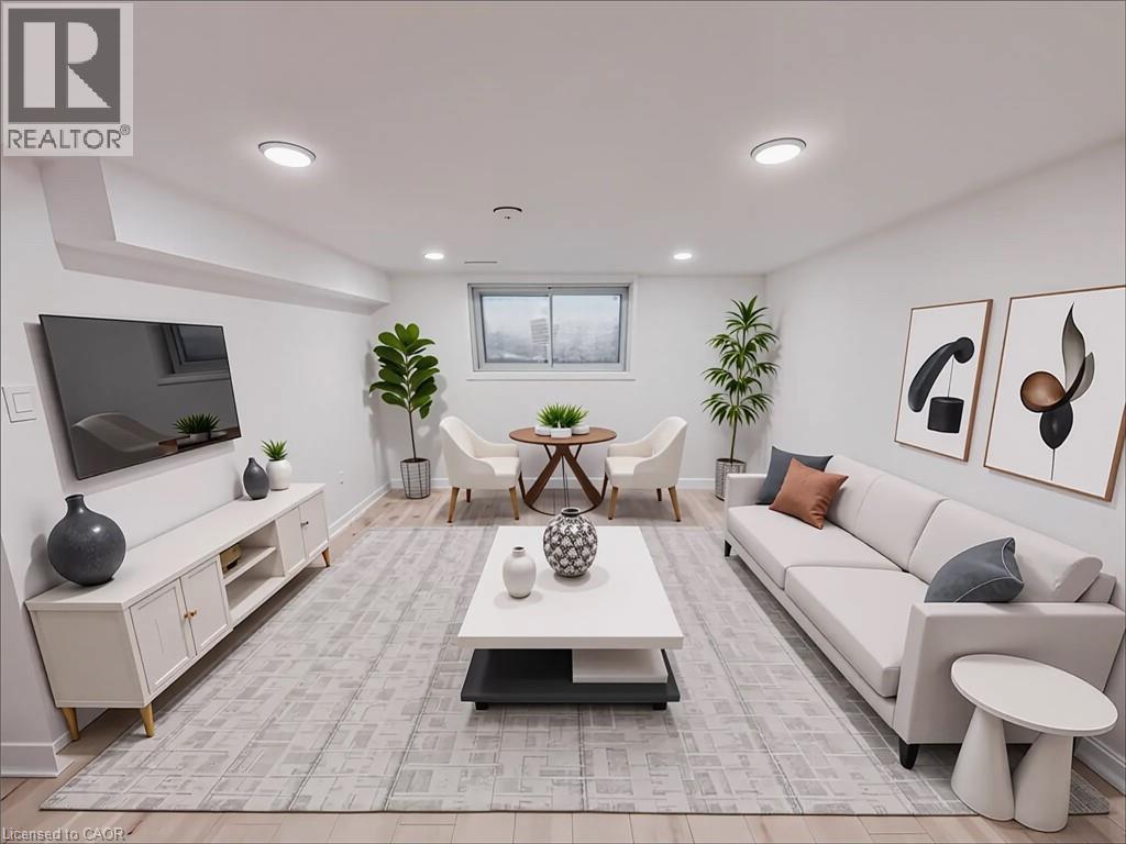 A living room with a grey carpet and white furniture.