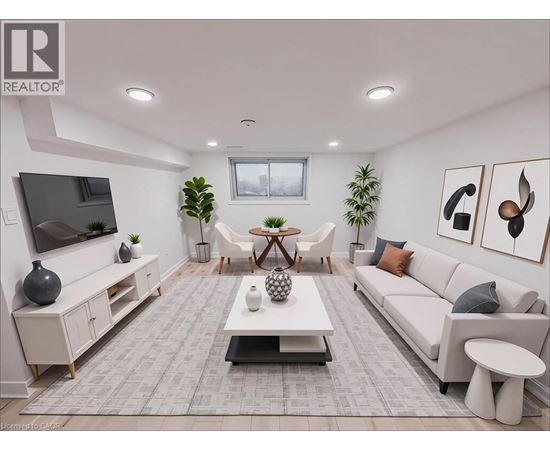 A living room with a grey carpet and white furniture.