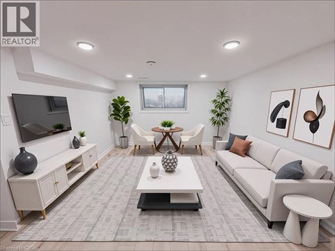 A living room with a grey carpet and white furniture.