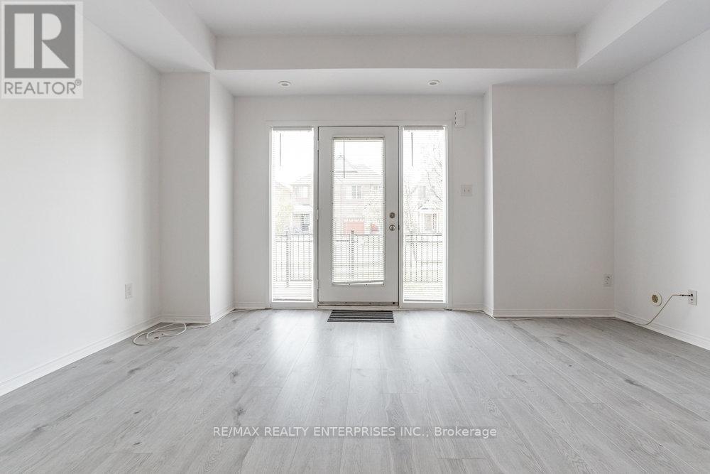 A spacious room with a door leading to a balcony.