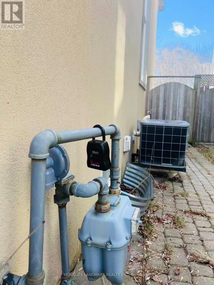 A blue water meter is installed on a sidewalk.