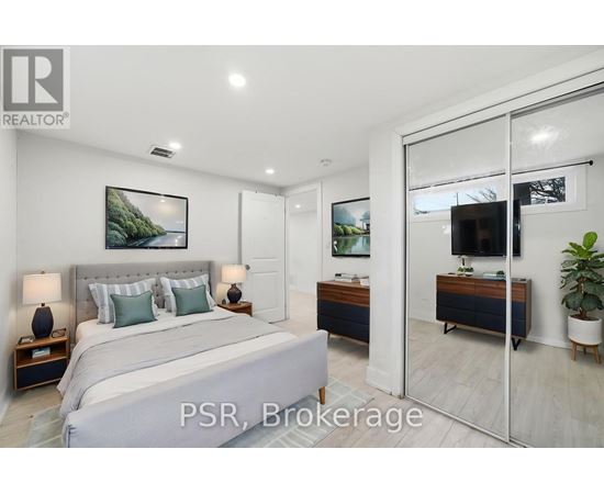 A bedroom with a large bed and a sliding glass door leading to a balcony.
