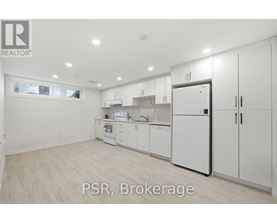 A kitchen with white appliances and cabinets is for sale.