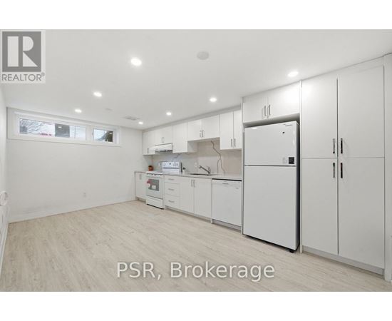 A kitchen with white appliances and cabinets is for sale.