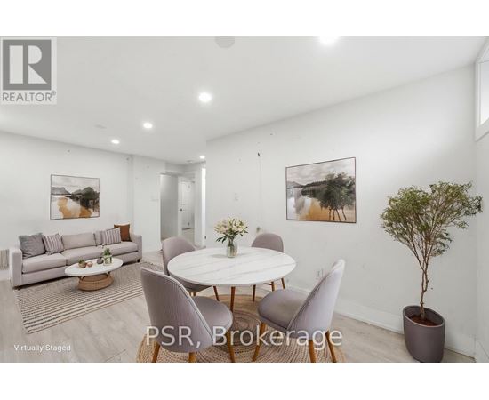 A modern living room with a dining table set up with chairs and a potted plant.