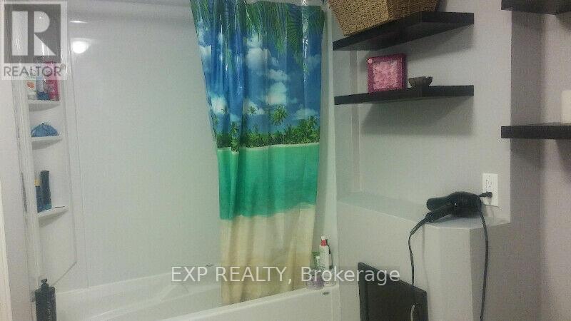A bathroom with a shower curtain and a shelf with a basket on it.