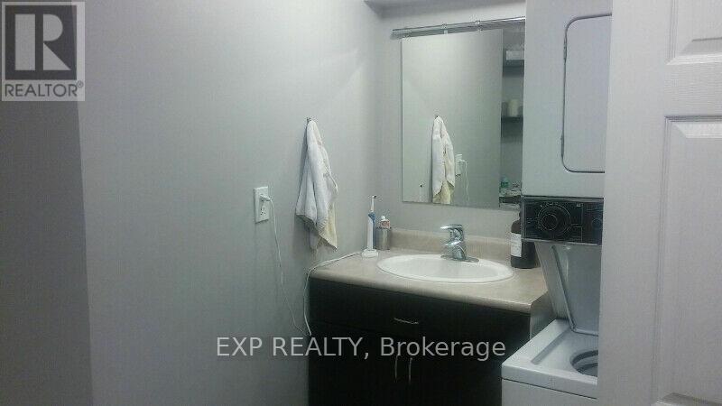 A bathroom with a sink, mirror, and towel rack.