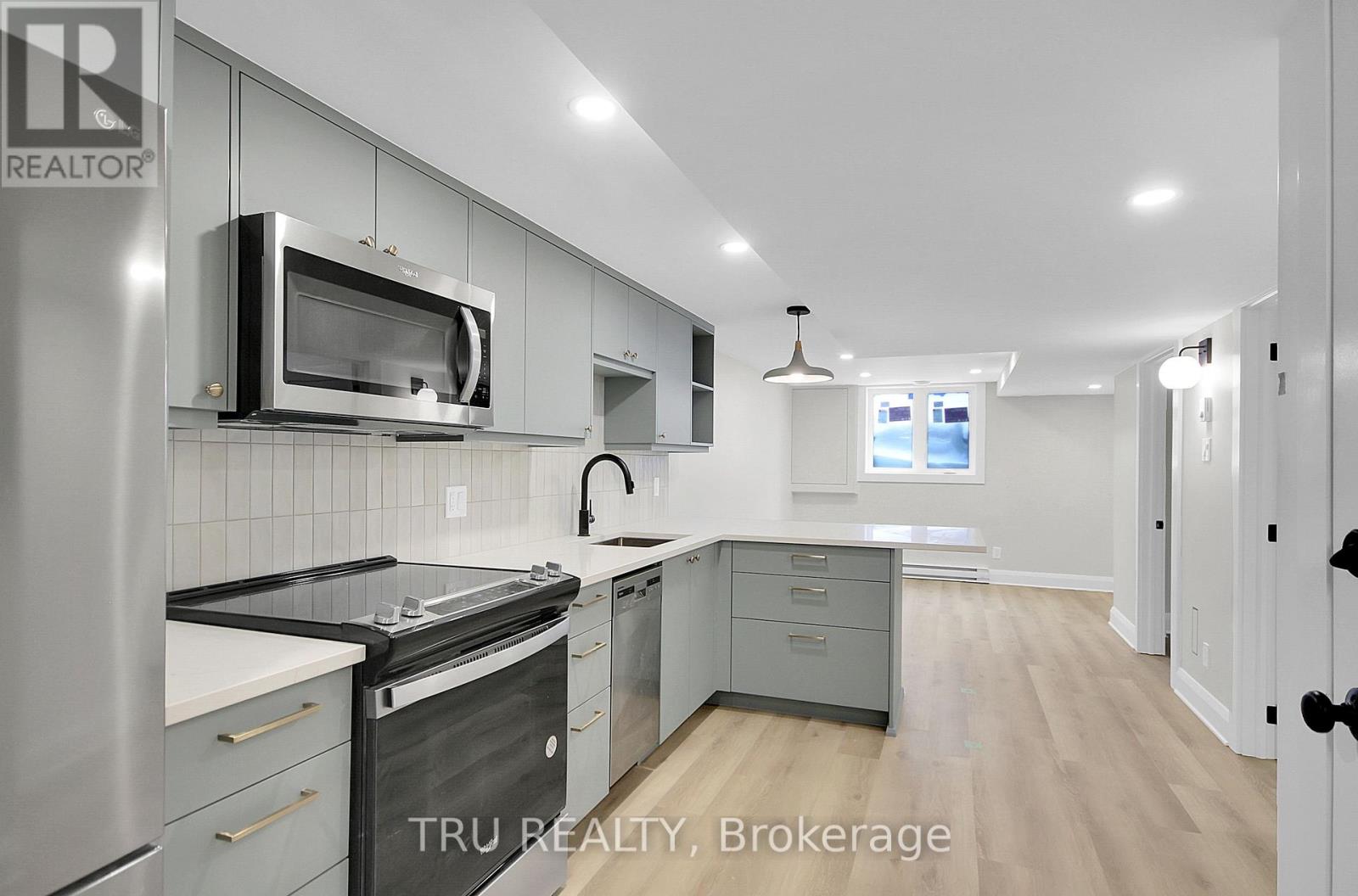 A modern kitchen with stainless steel appliances and a microwave above the stove.