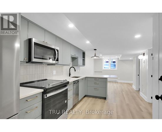 A modern kitchen with stainless steel appliances and a microwave above the stove.