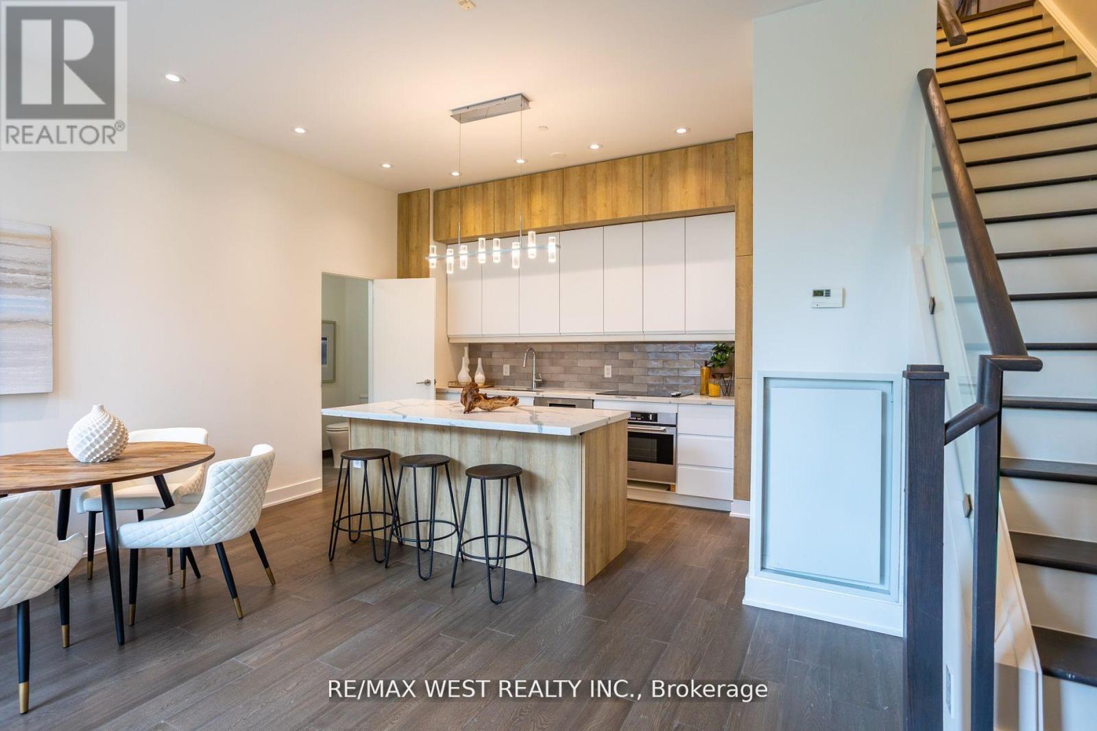 A modern kitchen with a dining table and chairs.