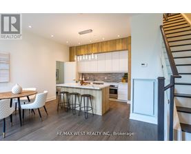 A modern kitchen with a dining table and chairs.