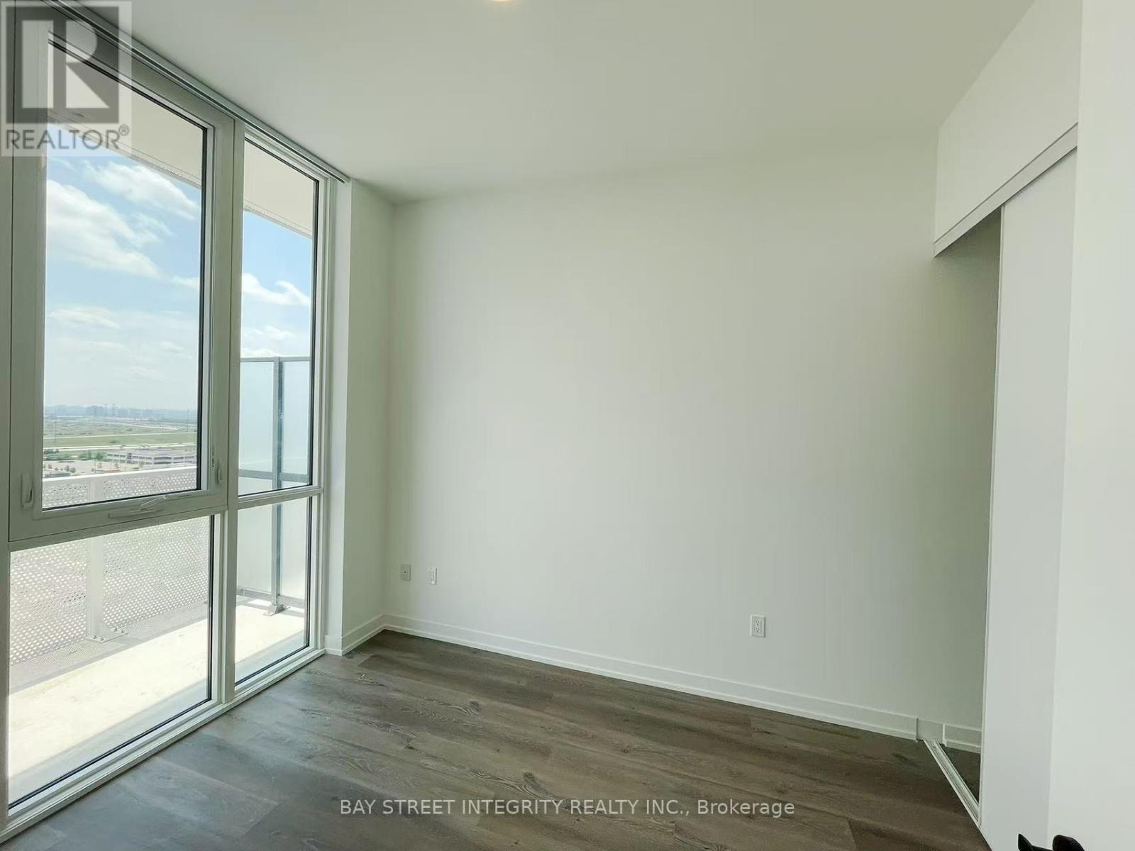 A room with a view of the outside through a large window.