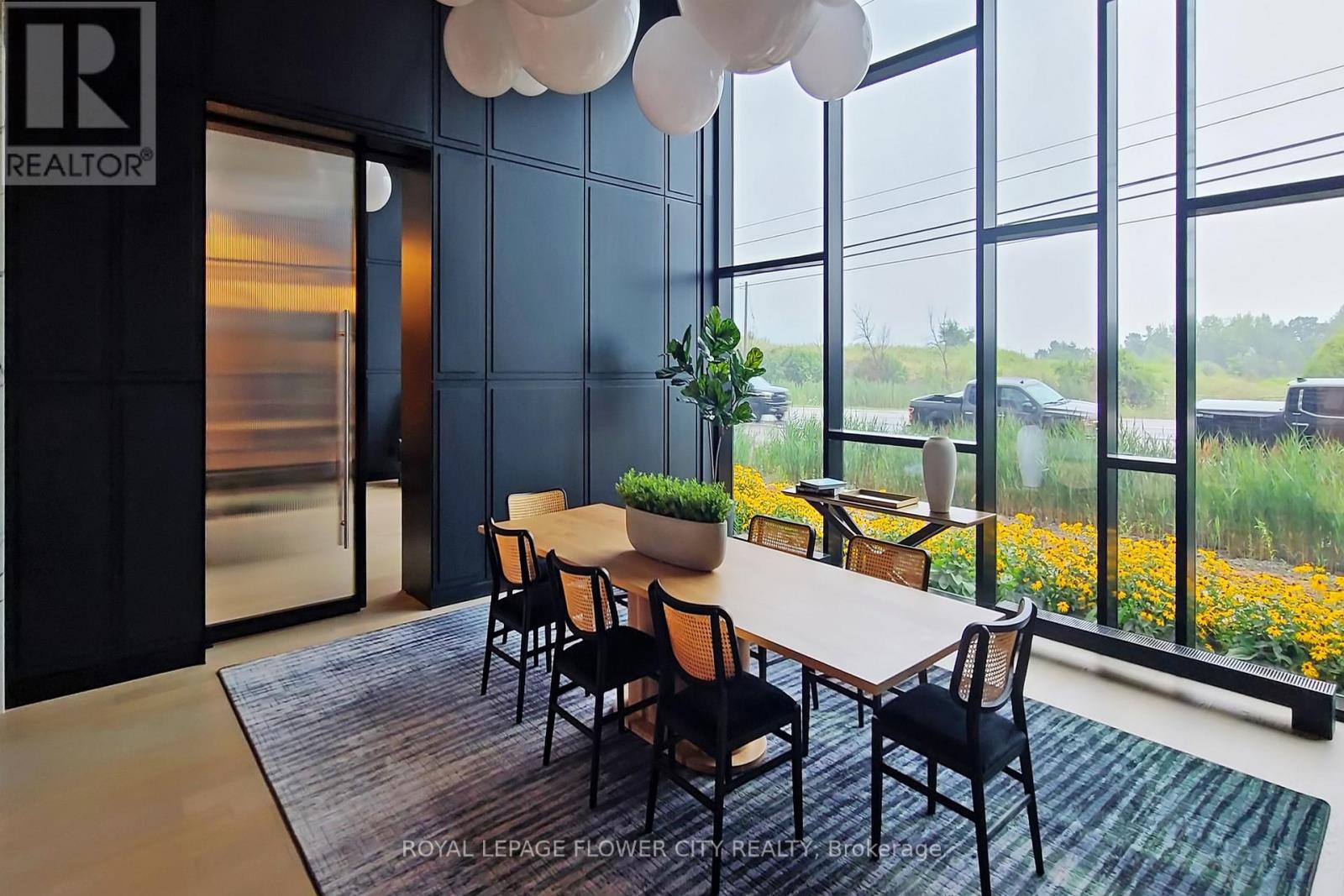 A conference room with a long table and chairs.