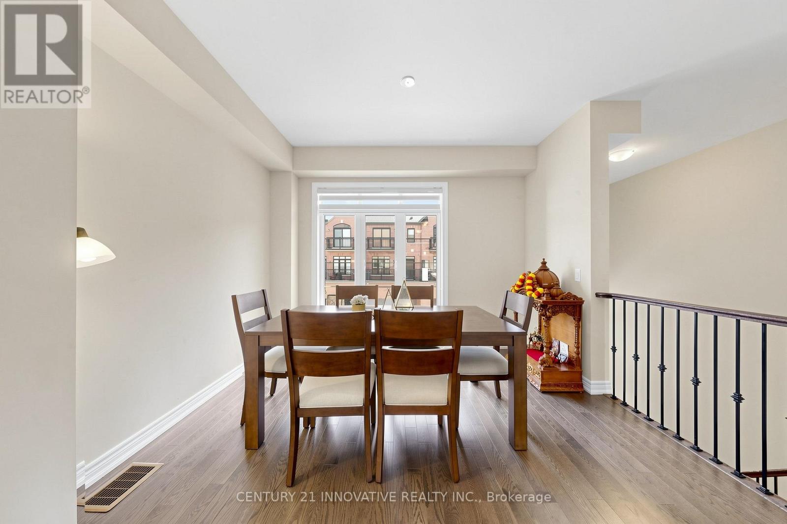 A dining room with a table and chairs and a window.