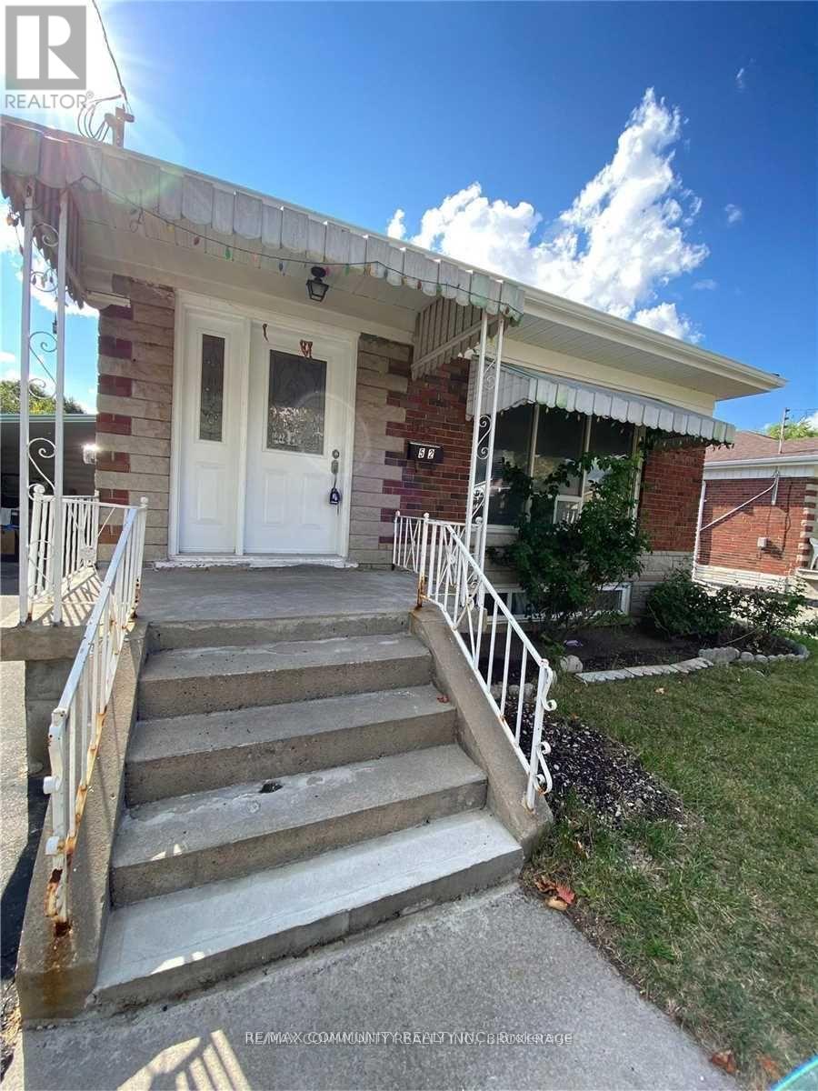 A house with a white door and stairs leading to it.