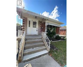 A house with a white door and stairs leading to it.