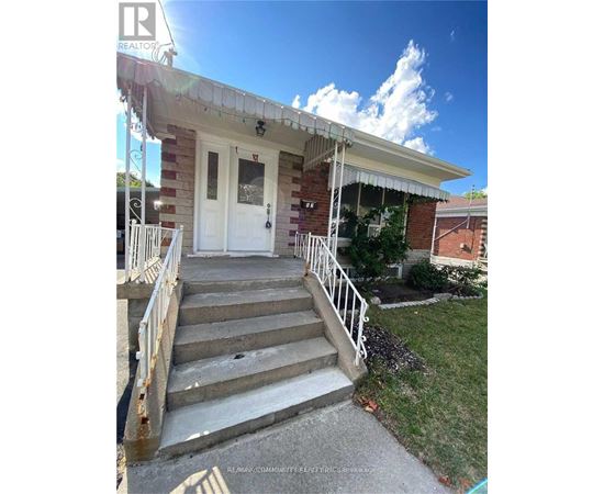 A house with a white door and stairs leading to it.