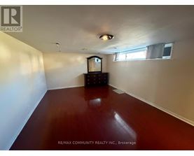 A room with a wooden floor and a television set.