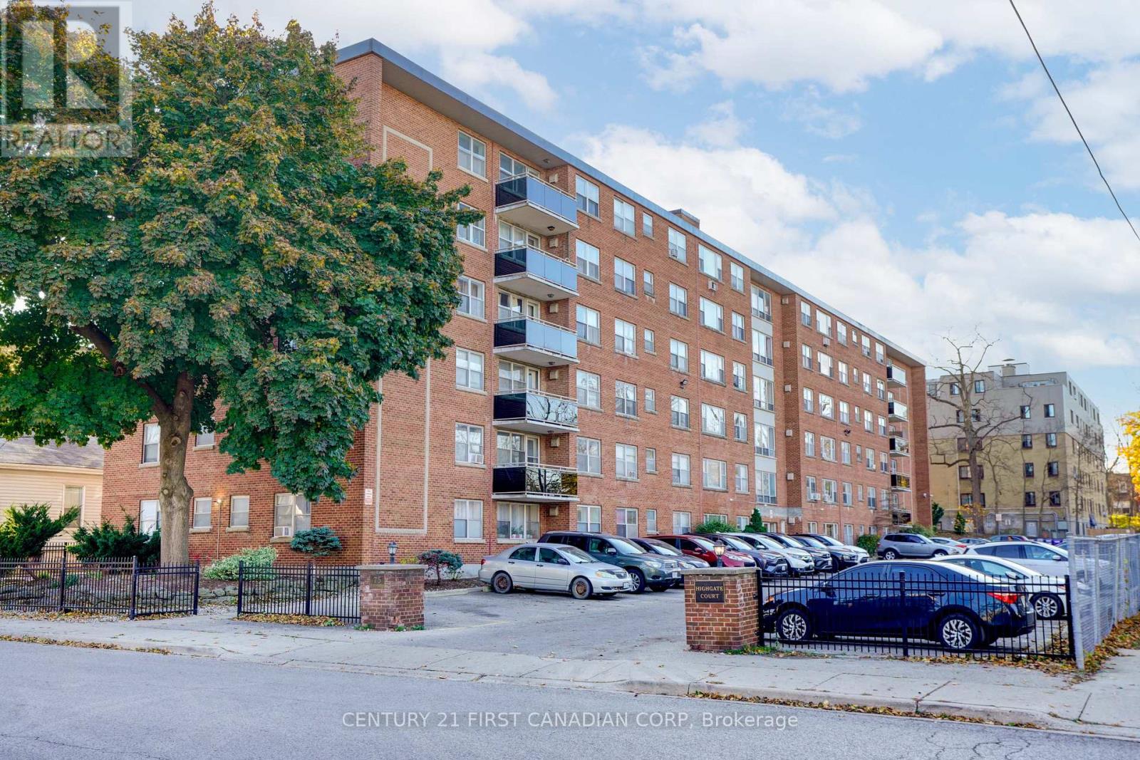 A large brick building with a parking lot in front.