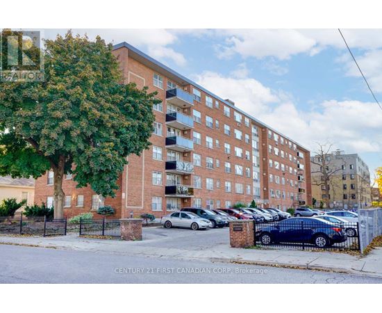 A large brick building with a parking lot in front.