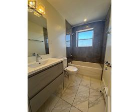 A bathroom with a toilet, sink, and bathtub.