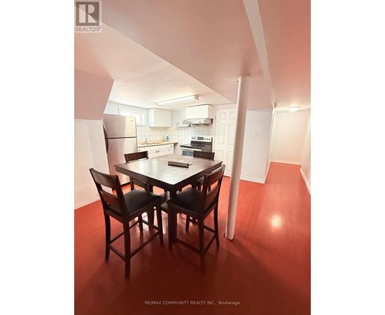A dining room with a table and chairs.