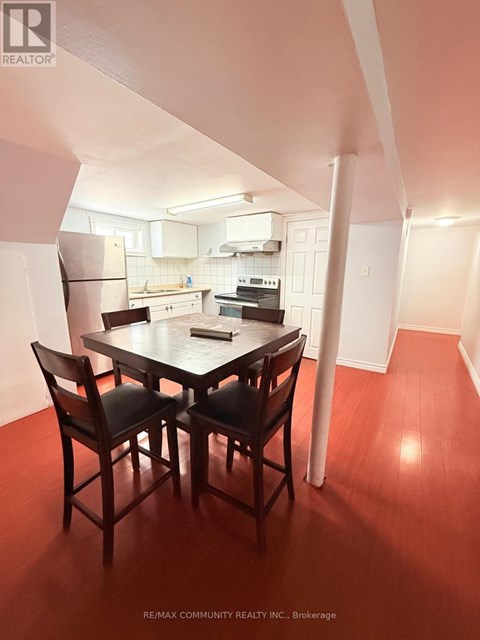 A dining room with a table and chairs.