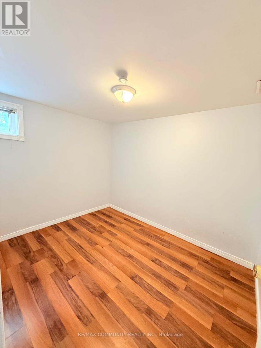 A room with wooden flooring and a window.