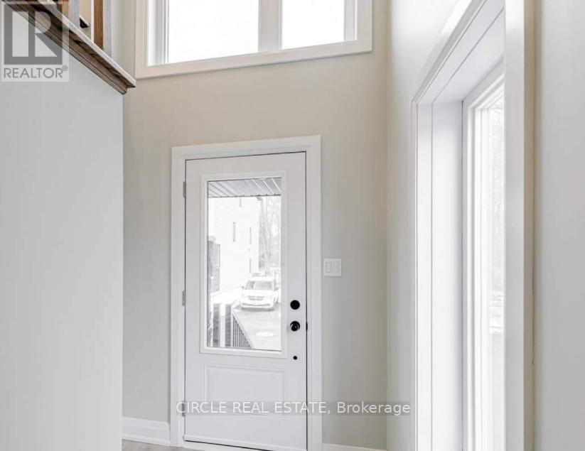 A white door with a glass window in the middle of a room.