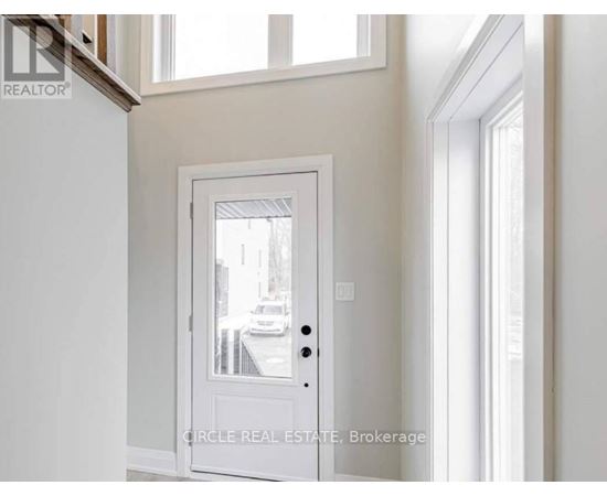 A white door with a glass window in the middle of a room.