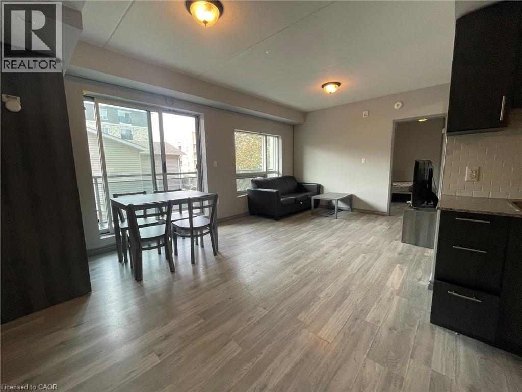 A living room with a dining table and chairs.