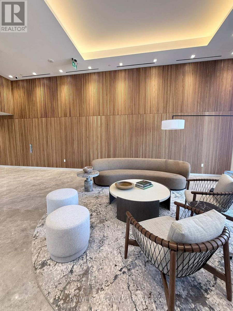 A modern living room with a wooden wall and a grey floor.