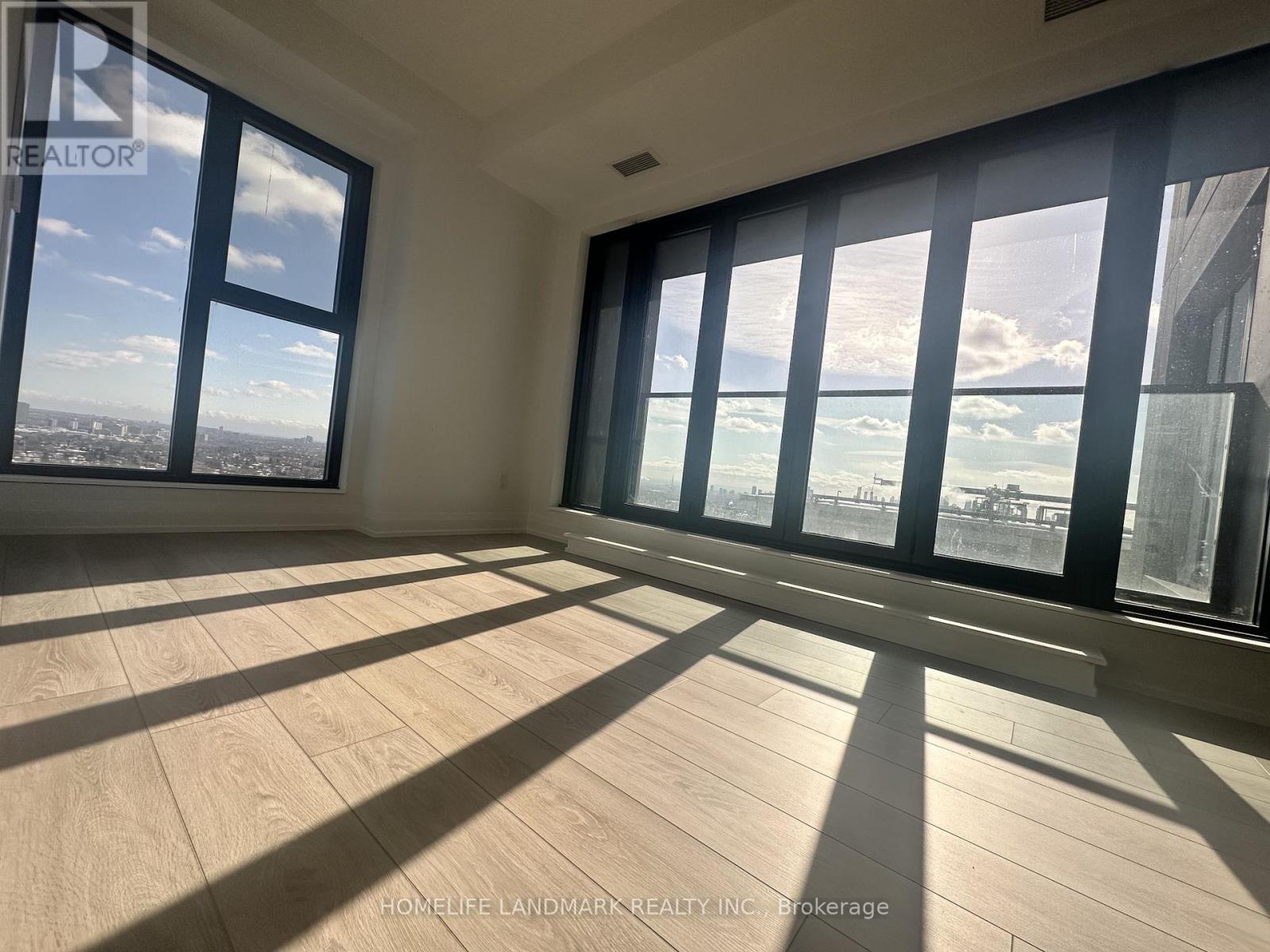 A sunny room with a view of the city and the ocean.