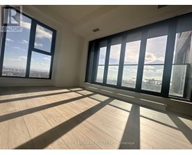 A sunny room with a view of the city and the ocean.