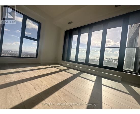 A sunny room with a view of the city and the ocean.