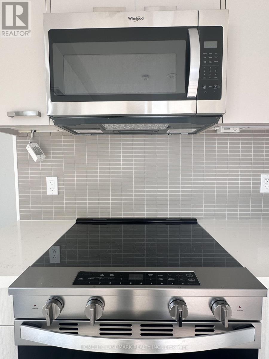 A stainless steel oven with a microwave above it in a kitchen.