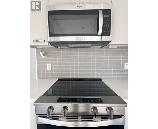 A stainless steel oven with a microwave above it in a kitchen.