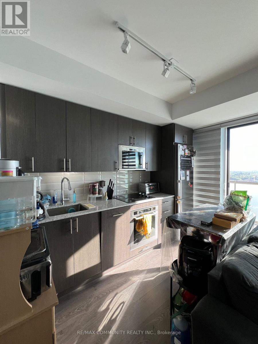 A kitchen with a sink, stove, and refrigerator is under construction.