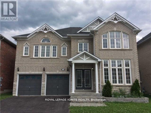 A large house with a grey roof and a white garage door.