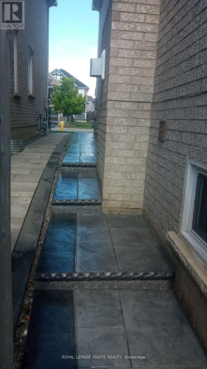 A wet sidewalk with a metal grate in the middle.