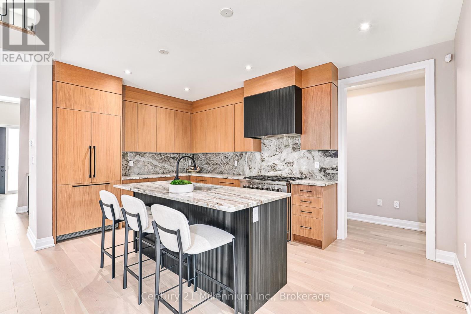 A kitchen with wooden cabinets and a marble countertop.