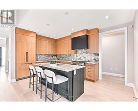 A kitchen with wooden cabinets and a marble countertop.