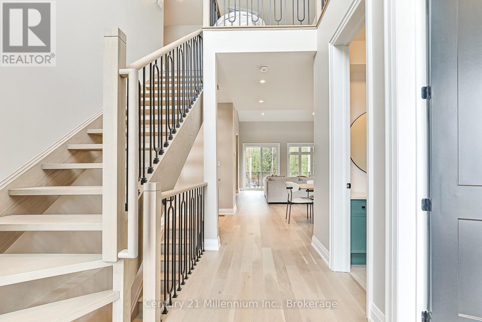A spacious hallway with a staircase leading to the upper floor.