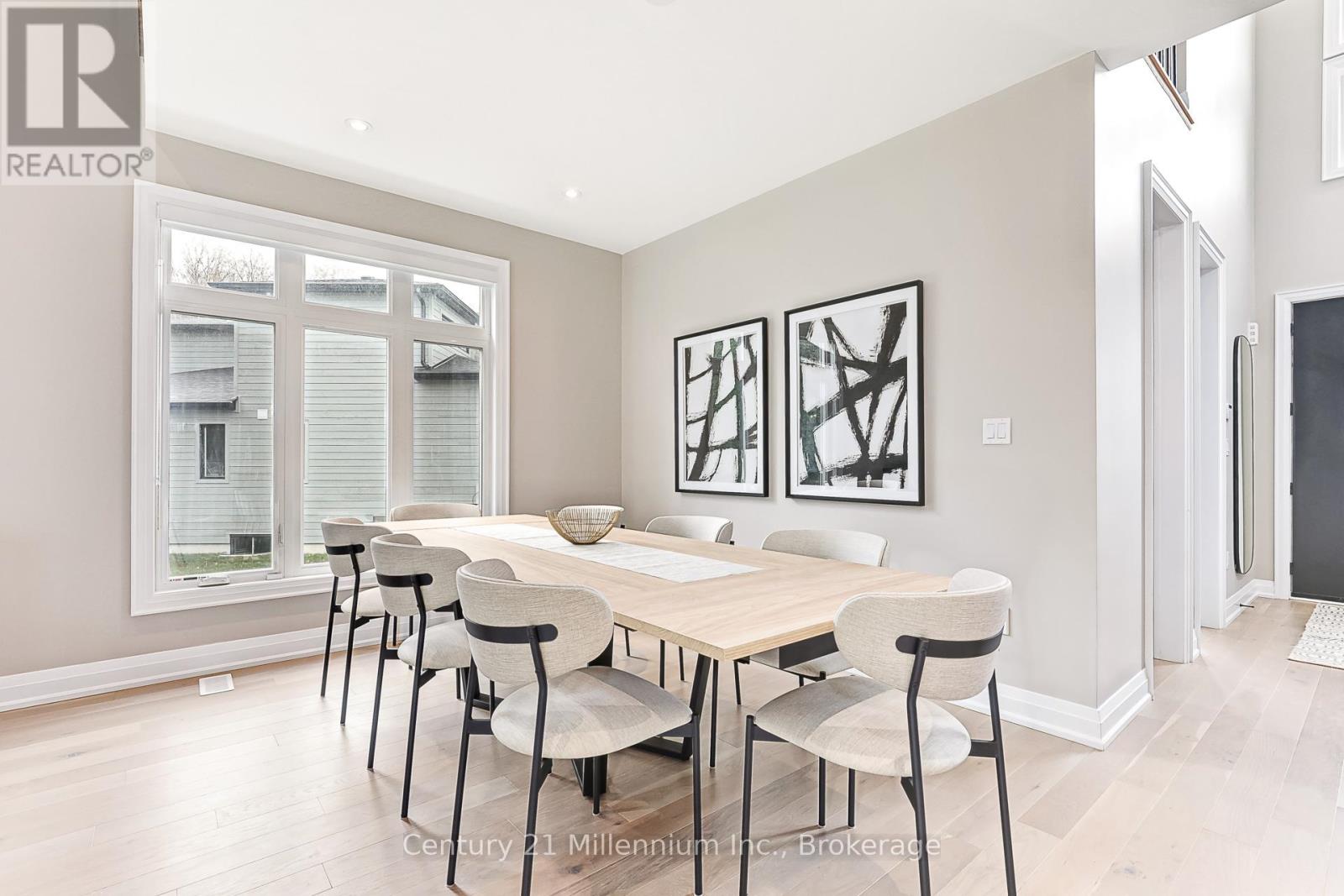 A dining room with a table and chairs.