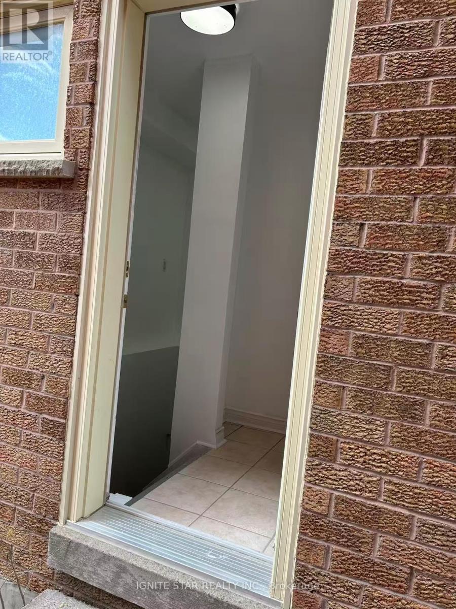 A doorway with a glass door and a brick wall.