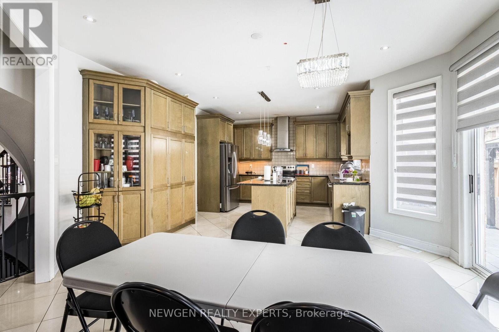 A modern kitchen with a dining table and chairs.