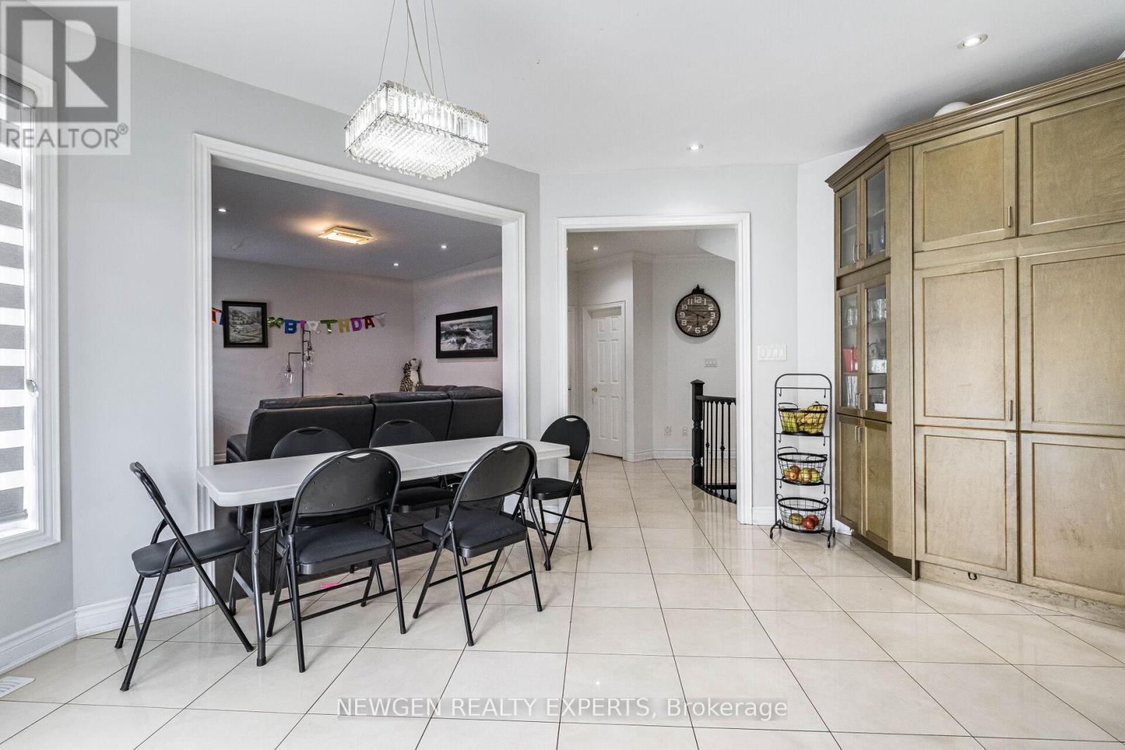A dining room with a table and chairs.