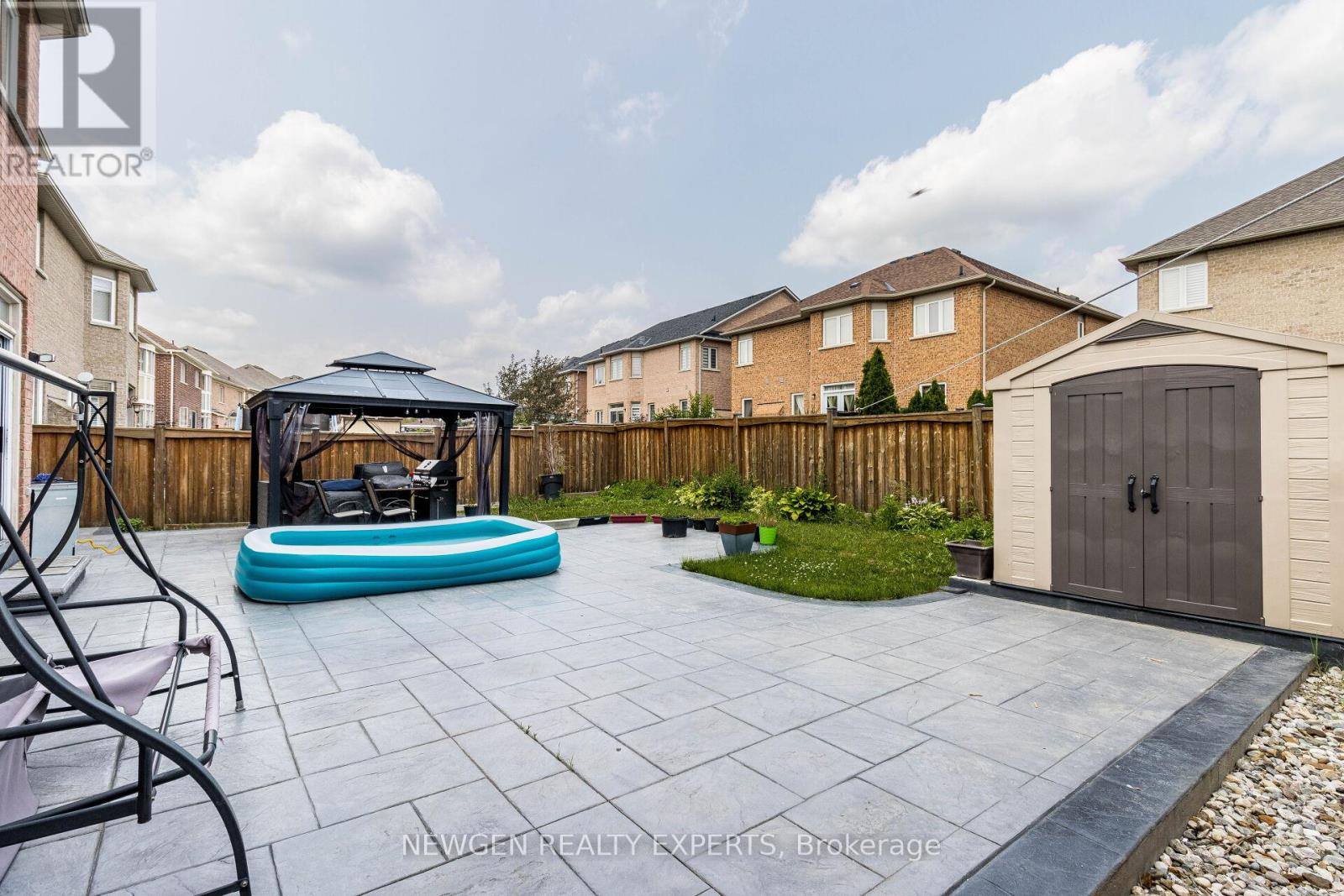 A backyard with a pool and a gazebo.