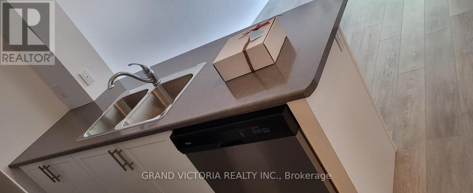 A kitchen with a sink and a dishwasher.